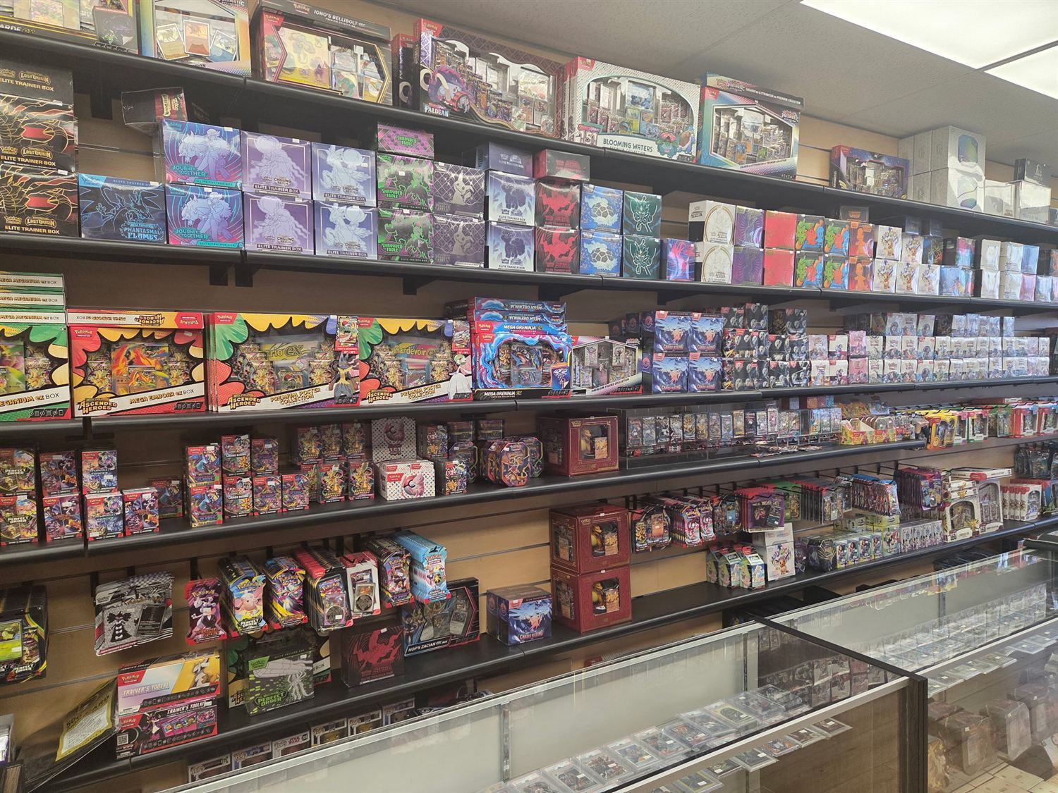 Wall of sealed Pokémon — Elite Trainer Boxes and premium collections at GG Hobby